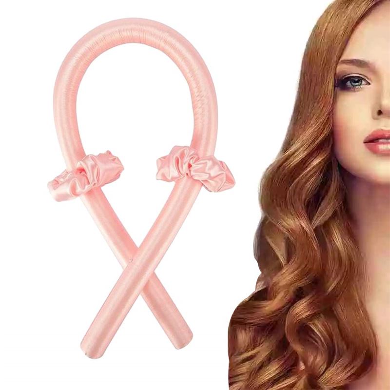 The Fashiongirl Heatless Hair Curlers in pink come with two matching scrunchies, shown beside a woman with long, shiny auburn curls—get beautiful curls without heat.