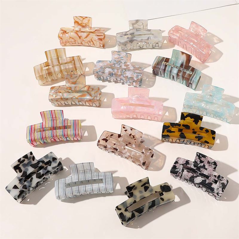 The SOHO Aria Hair Claw - Light Tortoise by SOHO is a large acetate hair clip, perfect for thick hair, featuring a stylish light tortoiseshell pattern and designed to hold hair securely in place.