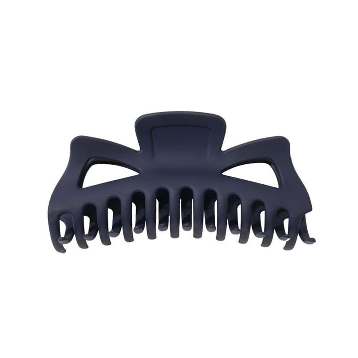 The SOHO Astrid Hair Claw in Navy features a matte dark blue finish, wide curved teeth, and an open geometric top—ideal for securing thick hair.