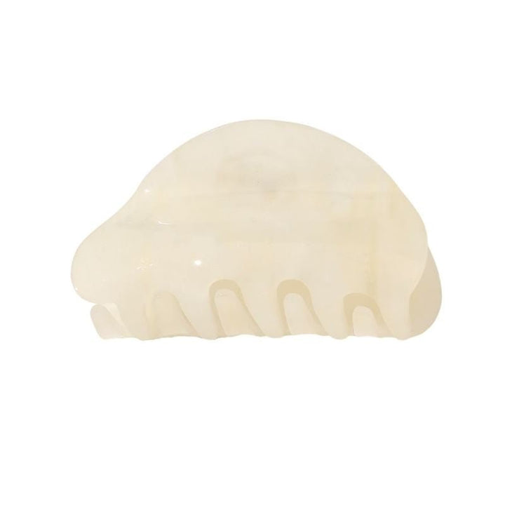 The SOHO Cleo Hair Claw - White by SOHO is a translucent, off-white, medium-sized clip with a curved, semi-circular design and five wide teeth, shown on a plain white background.