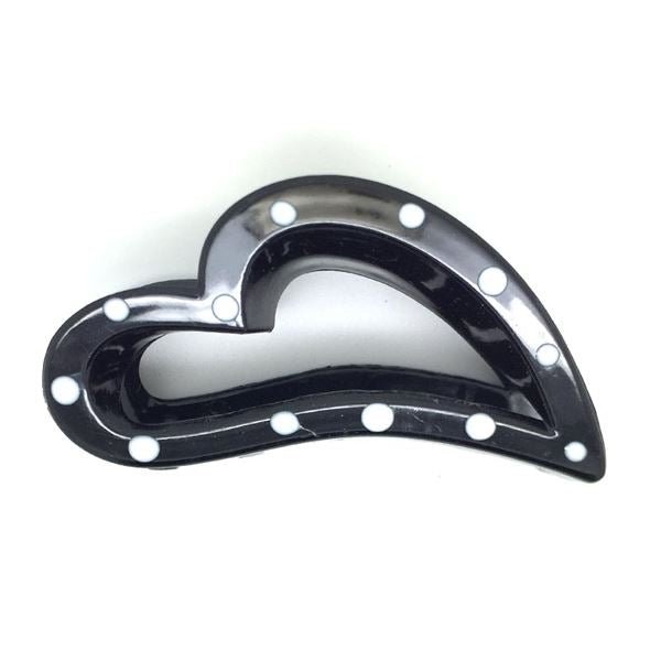The SOHO Heart Hair Claw by SOHO features a black, heart-shaped design with white polka dots along the outer edge, shown against a plain white background.