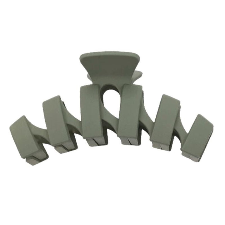 The SOHO Just Hair Claw in matte gray-green features five wide rectangular prongs and a curved shape—an elegant SOHO accessory for effortless hair styling.