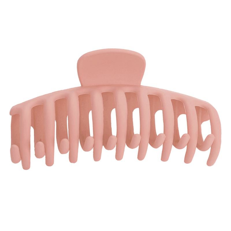 The SOHO Kana Hair Claw in Peach Beige features wide, rounded teeth and a curved design for a secure grip on all hair types. Made of pink plastic, it's shown against a white background.