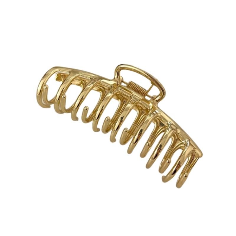 The SOHO Kana Metal Hair Claw in gold features a large, curved design with interlocking teeth for a strong grip, suitable for all hair types.