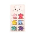 Le SOHO Lala Mini Hair Claws - Flowers by SOHO comprend six mini-pinces colorées (rose, rouge, jaune, bleu, turquoise, violet) sur une carte blanche avec une jolie illustration représentant un visage de chat.