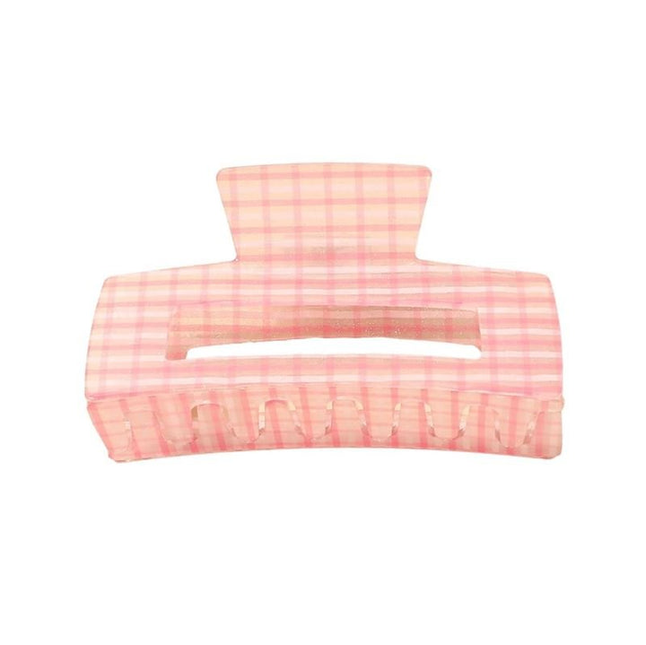 The SOHO Line Hair Claw - Pink by SOHO features a large, rectangular design with a pink chequered pattern and a central horizontal opening—perfect for securely holding your hair.