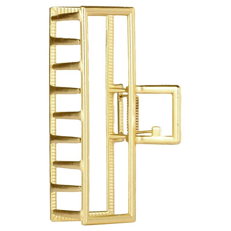 La grande pince à cheveux métallique SOHO Niba en or présente un design géométrique rectangulaire en échelle avec des barres parallèles, une structure ouverte et une charnière et un fermoir latéraux sécurisés, idéale pour créer des chignons désordonnés avec élégance de SOHO.