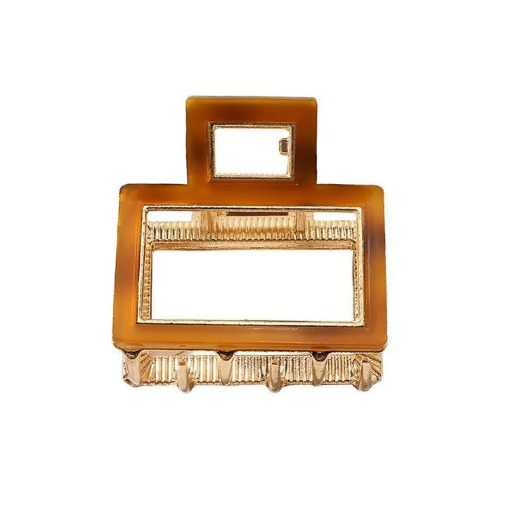 The SOHO Vida Hair Claw - Brown by SOHO features a rectangular brown and gold metal design with geometric cutouts and ridged edges—a chic accessory to elevate any look.