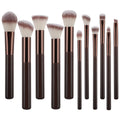 Le set de pinceaux de maquillage Technique PRO Chocolate Bronze comprend 11 pinceaux professionnels avec des manches marron foncé et des viroles en or rose, présentant différentes formes de têtes de pinceaux, comme un pinceau à fond de teint, disposés à la verticale sur un fond blanc.