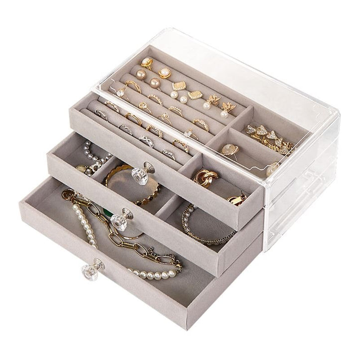 The UNIQ Acrylic Jewellery Organiser with 3 drawers - J305 by UNIQ features gray velvet-lined compartments, keeping rings, earrings, bracelets, and necklaces neatly organised.